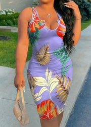 Woman wearing a colorful floral dress with a purple base, standing outdoors.