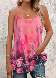Woman wearing a pink floral tank top against a textured wall.