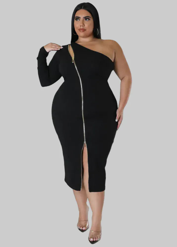 Woman wearing a black one-shoulder dress with a zipper in a bright room.