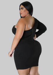 Woman wearing a black one-shoulder dress against a gray background