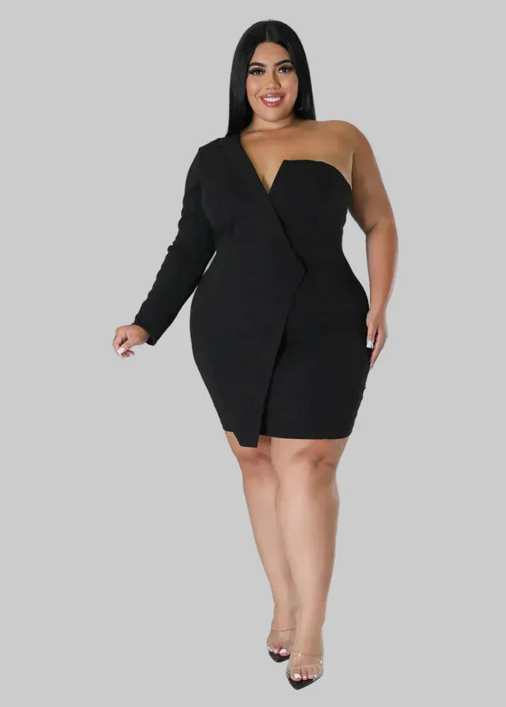 Woman wearing a black strapless dress with a draped front on a gray background