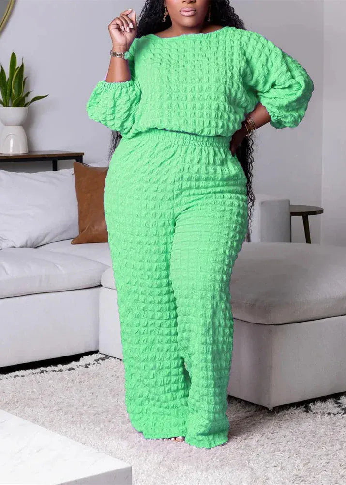 Woman wearing a bright green textured outfit in a living room setting.