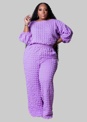 Woman wearing a purple textured outfit with 'Wmstar' branding on a white background