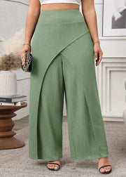 Person wearing green wide-leg pants in a room setting