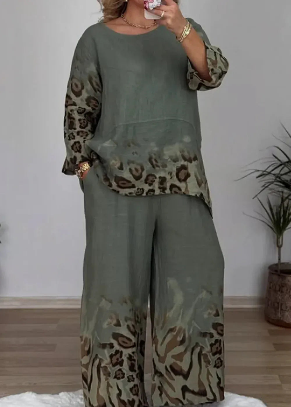 Person wearing a green outfit with leopard print details in a room.