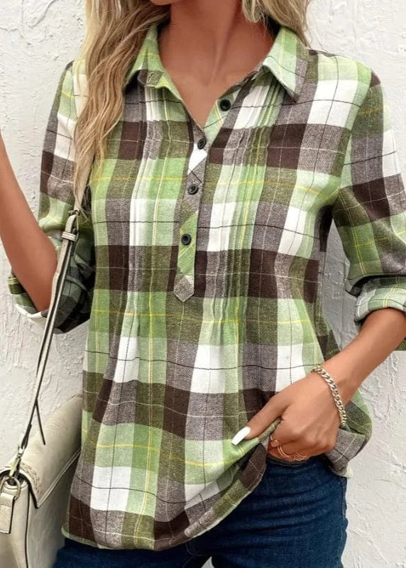Person wearing a green and brown plaid shirt against a white background