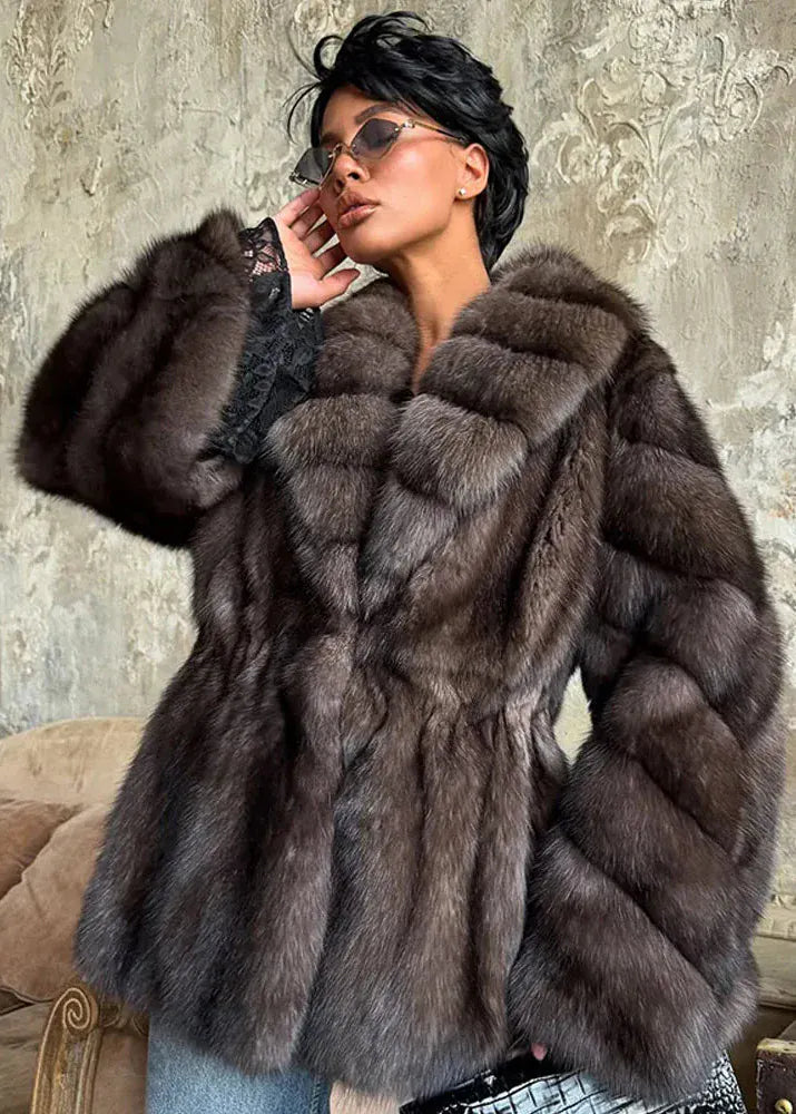 Woman wearing a fur coat in an elegant setting