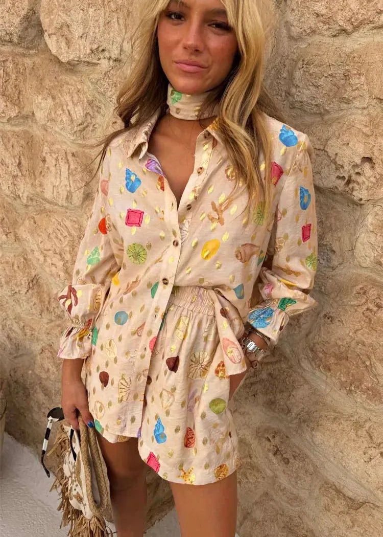 Woman wearing a colorful patterned dress against a stone wall.