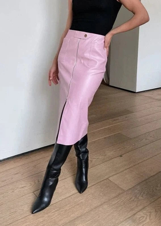 Person wearing pink pants and black boots on a wooden floor.