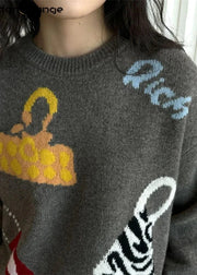 Gray sweater with colorful designs and text, brand 'Hood and Gong' visible.