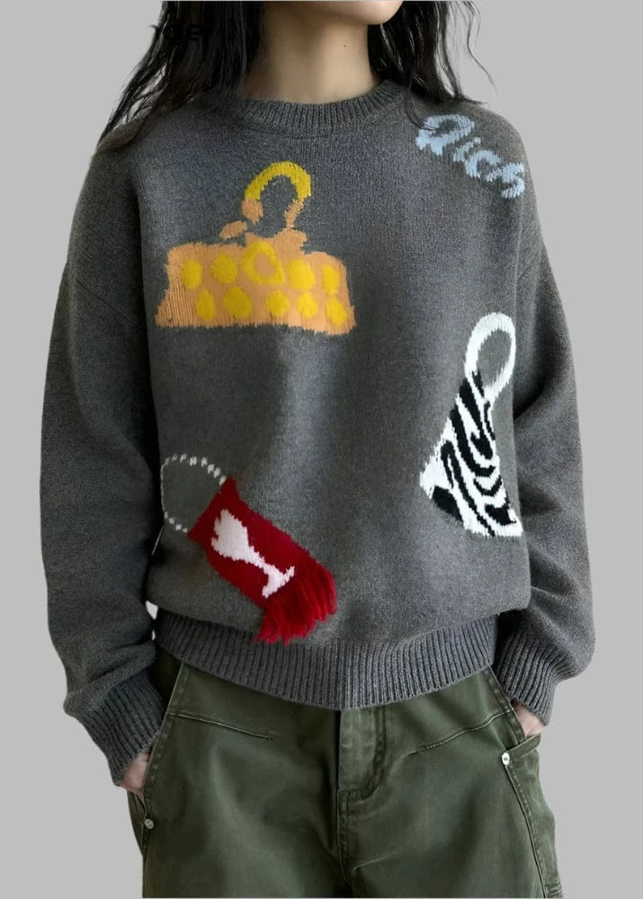 Person wearing a dark gray sweater with colorful graphic designs against a white background
