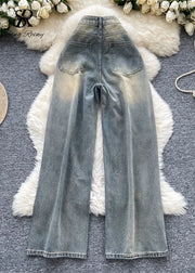 Blue denim jeans on a textured surface with decorative elements