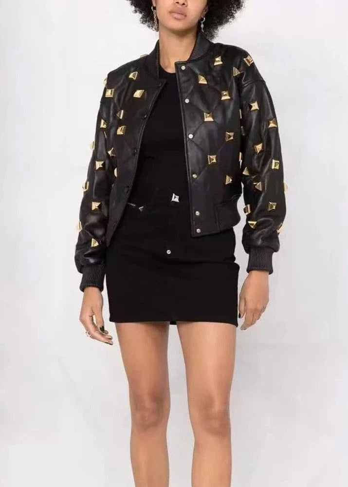 Person wearing a black jacket with gold patterns on a white background