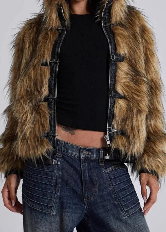 Person wearing a fur-lined jacket with a plain background