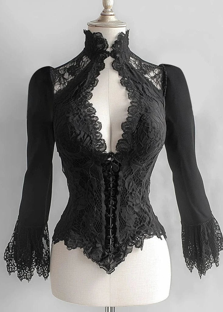 Black lace top on a mannequin against a gray background