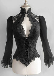 Black lace top on a mannequin against a gray background