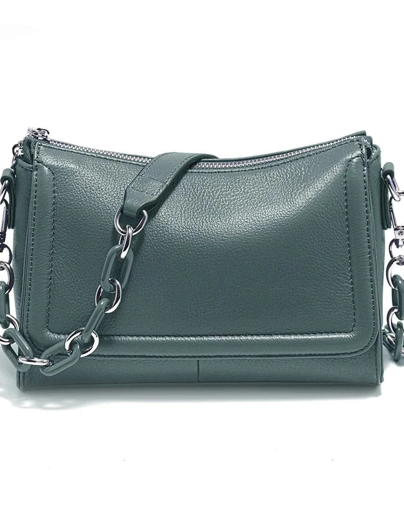 A white genuine leather top-handle bag with silver chains and a zipper closure.