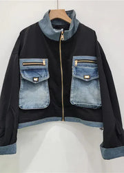Black jacket with denim accents on a white background