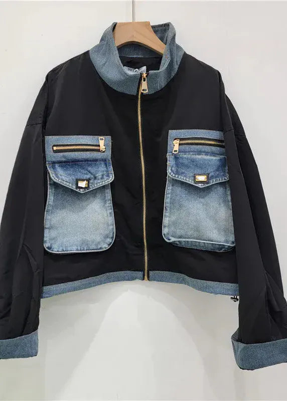 Black jacket with denim accents on a white background