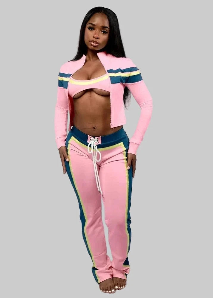 Woman wearing a pink tracksuit with colorful accents on a white background, featuring the brand 'FLARORA'.