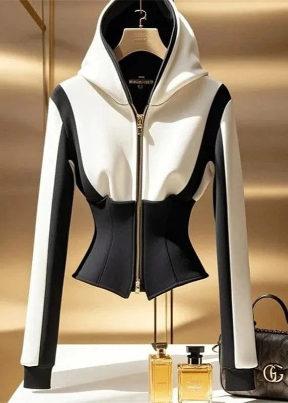 Black and white hoodie with a handbag and perfume bottles on a gold background