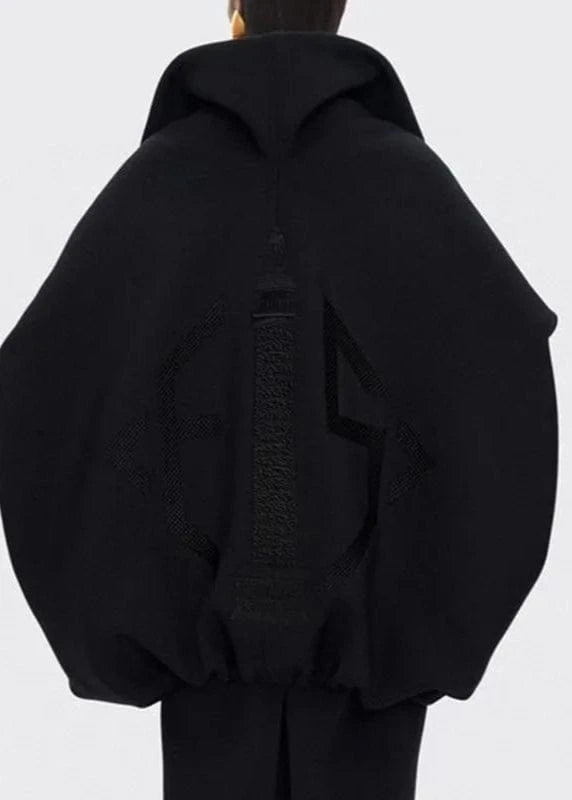 Black hoodie with a textured pattern on the back against a white background