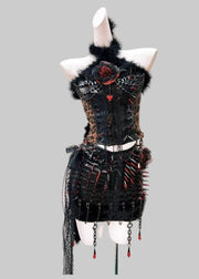 Black decorative dress with floral elements on a mannequin against a light pink background