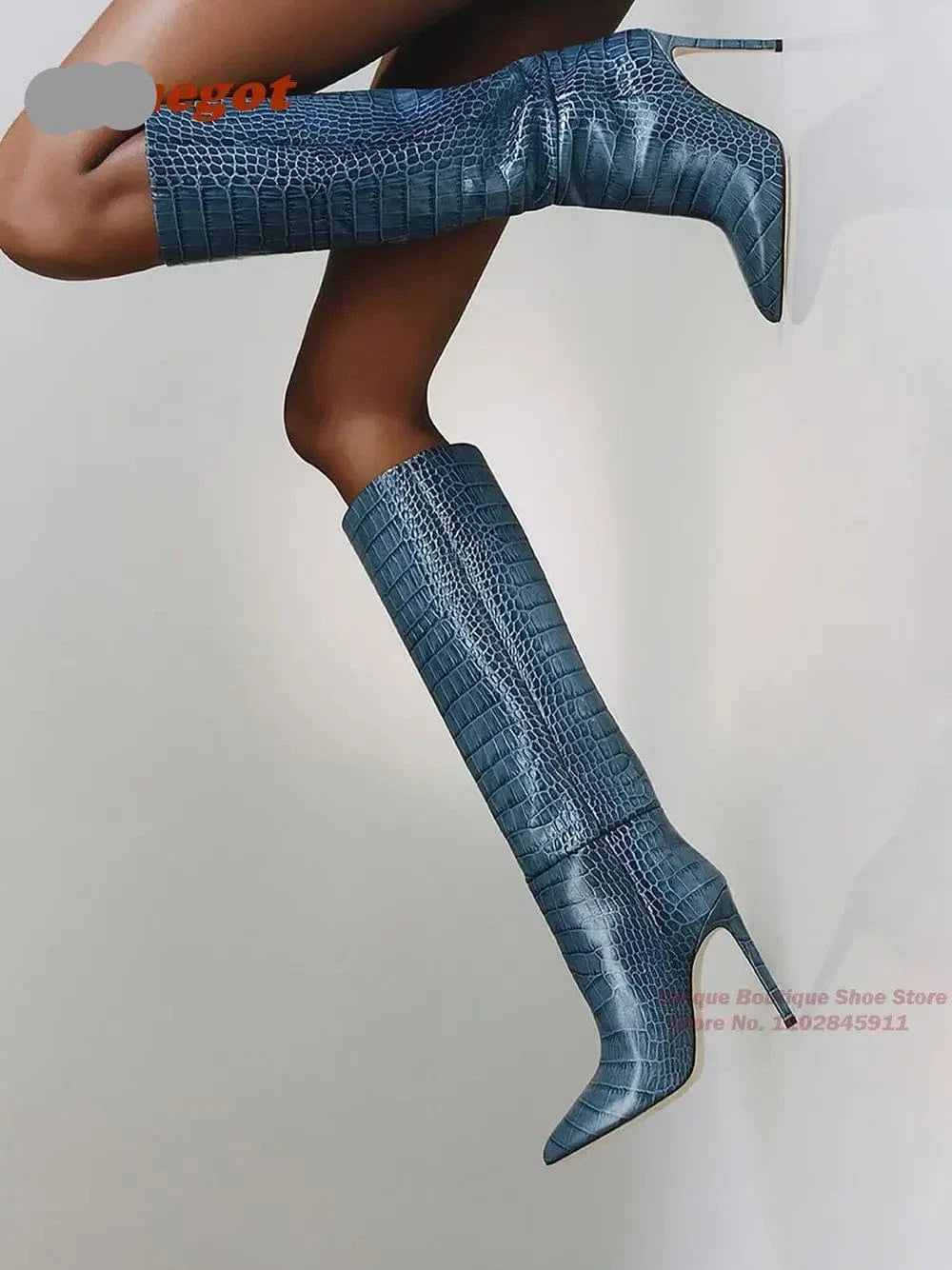 Blue crocodile-patterned knee-high boots on a model against a gray background, with 'Hemengot' branding.