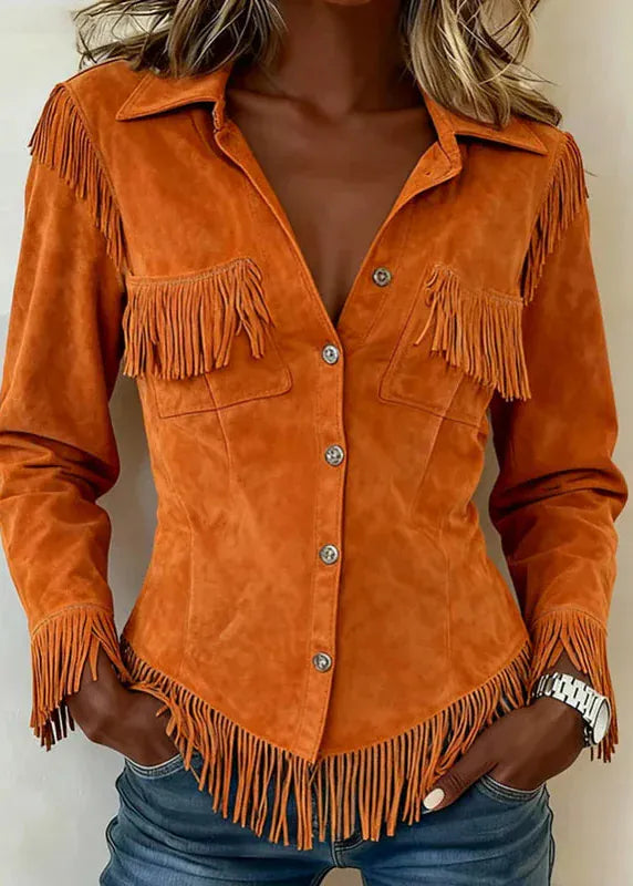 Orange suede jacket with fringes on a plain background