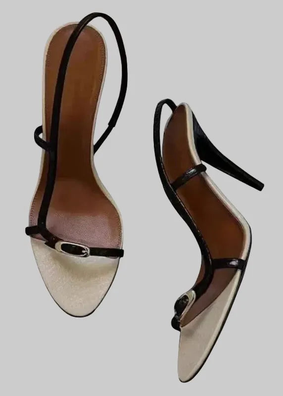Pair of high-heeled shoes with a strap on a white background