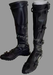 Black knee-high boots with buckles on a white surface