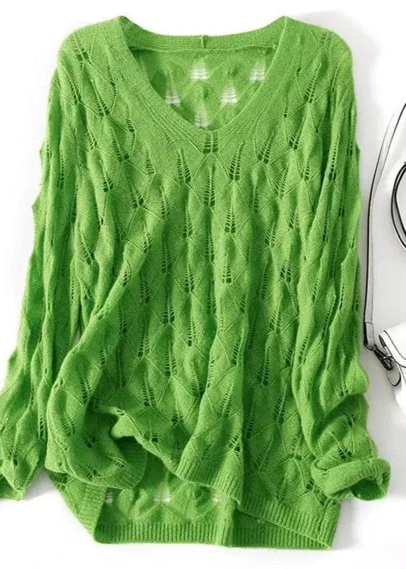 Green knitted sweater on a white background