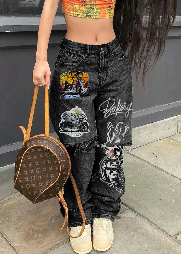 Person wearing black jeans with patches, holding a brown handbag, standing on a pavement.