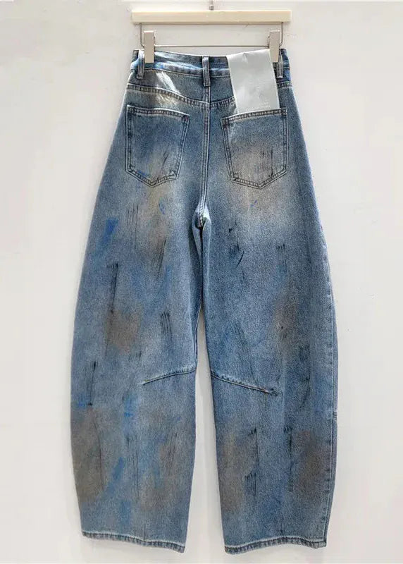 Blue jeans with paint splashes on a white background