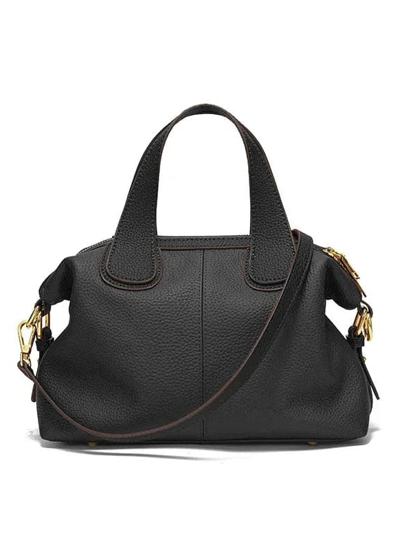 A beige underarm leather French tote bag with a zipper closure and diamond pattern, displayed alongside a small green item for scale comparison.