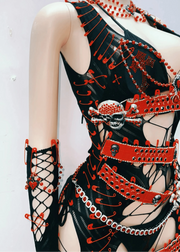 Mannequin wearing a black and red dress with intricate designs on a white background