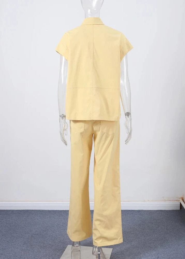 Mannequin wearing a yellow outfit on a plain background
