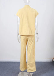 Mannequin wearing a yellow outfit on a plain background