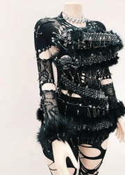 Black and white outfit with intricate design on a mannequin against a light background