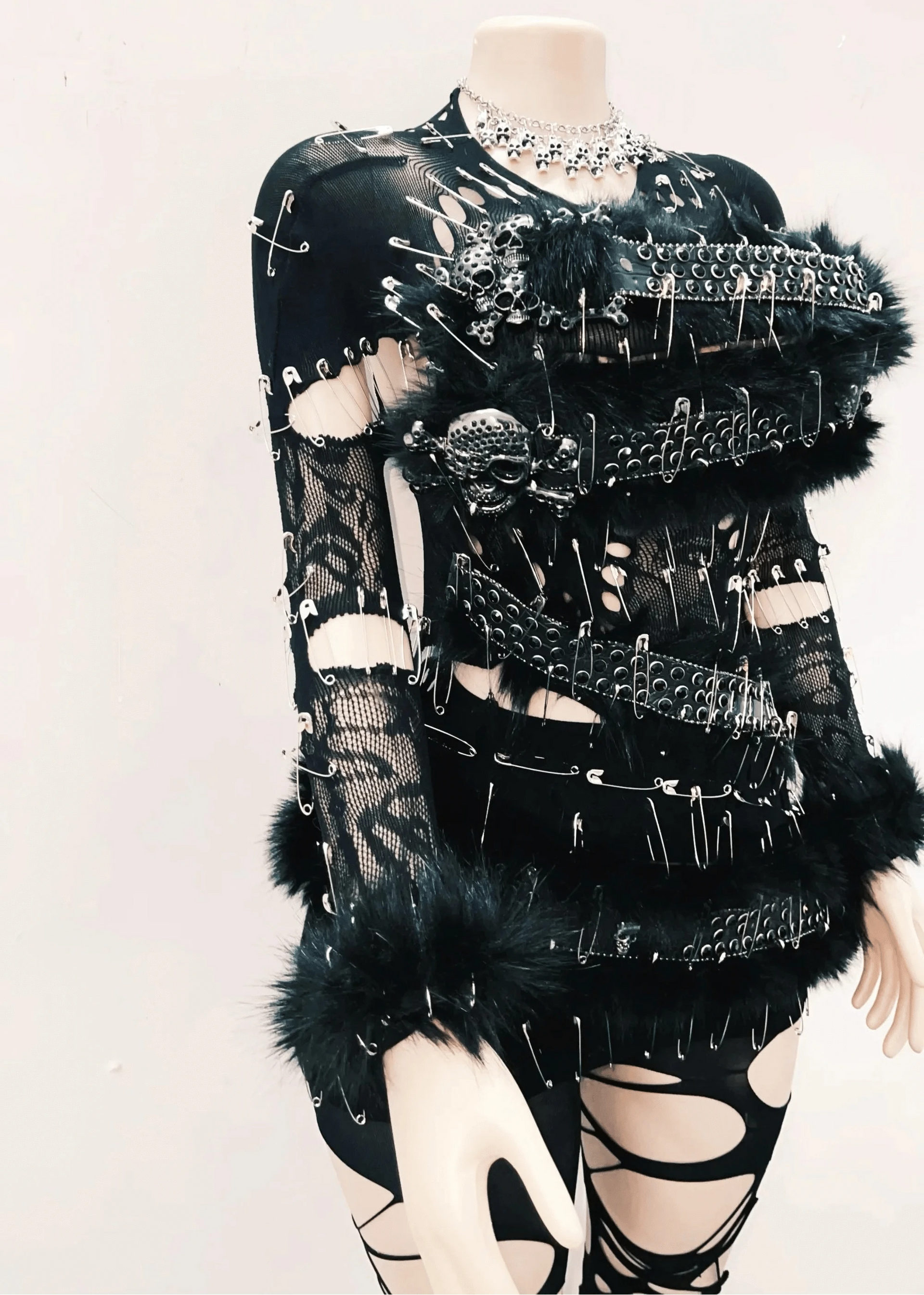 Black and white outfit with intricate design on a mannequin against a light background