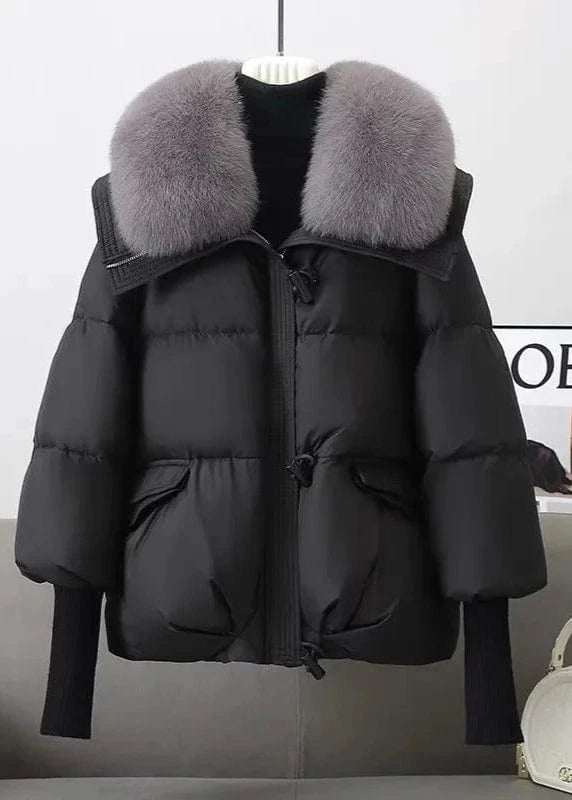 Black puffer jacket with gray fur collar on a white background