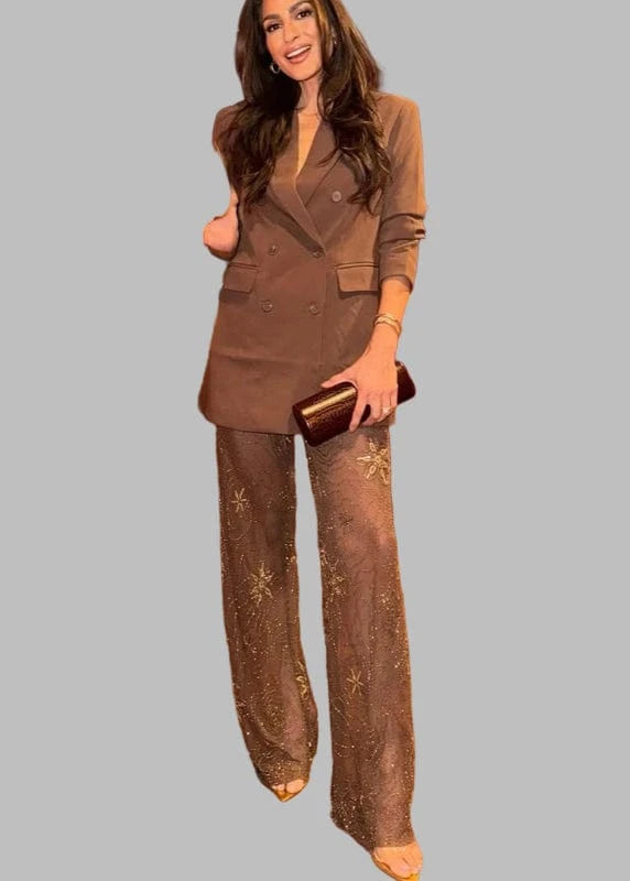 Woman in a stylish outfit standing in a bar setting