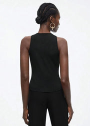 Person wearing a black sleeveless top and pants on a white background