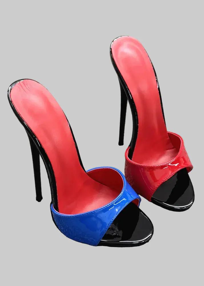 Red and blue high-heeled shoes on a textured surface with a neutral background