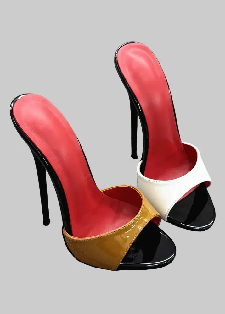 Colorful high-heeled shoes on a textured surface with a stone wall background