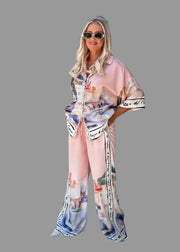 Woman wearing a patterned outfit with sunglasses in an outdoor setting