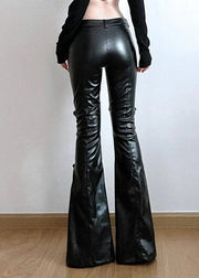 Black leather flared pants worn by a person on a plain background