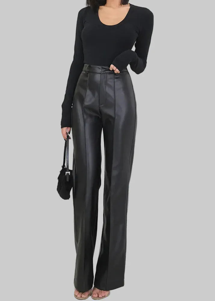 Person wearing black leather pants and a black top with a white background, featuring the brand 'Lautaro'.