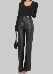 Person wearing black leather pants and a black top with a white background, featuring the brand 'Lautaro'.