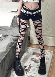 Person wearing black lace-up leggings in a bedroom setting